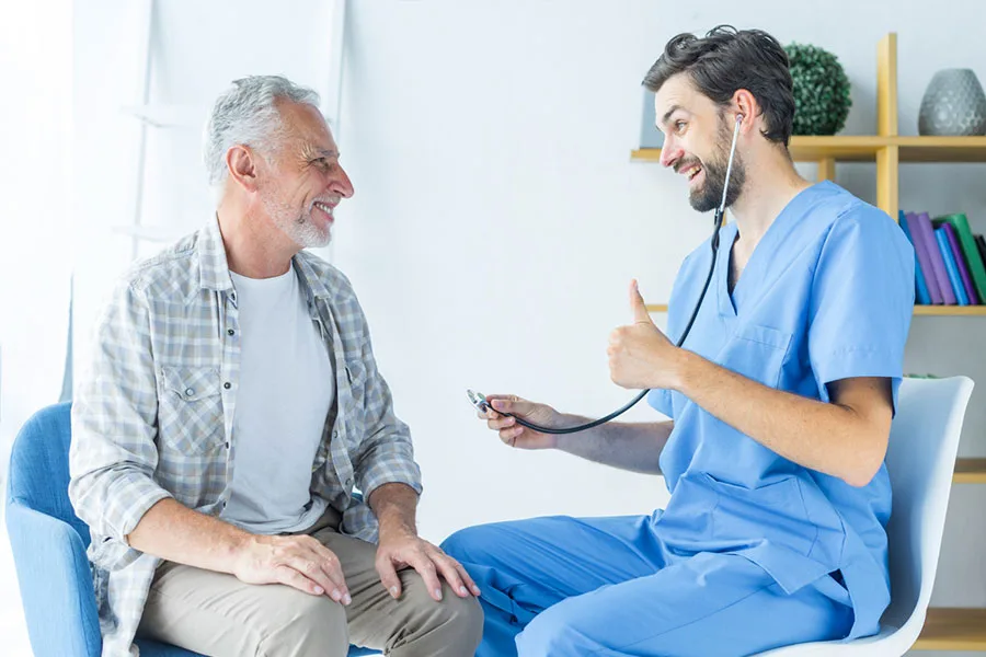 Primary Care young-doctor-gesturing-thumb-up-to-elderly-patient-Tampa-florida